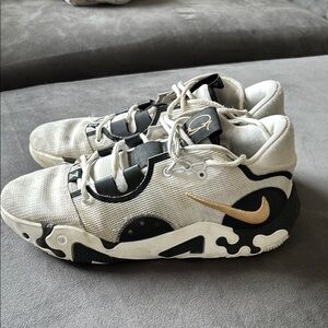 Nike White and Black Sneakers with Gold Swoosh